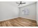 A clean, airy room is highlighted with wood floors, white walls, and natural light from the windows at 12910 Prestwick Dr, Riverview, FL 33579