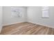 Minimalist bedroom with wood flooring and a bright window, offering a serene and uncluttered space at 12910 Prestwick Dr, Riverview, FL 33579