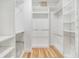 Bright walk-in closet with custom shelving, providing ample storage space and organization at 12910 Prestwick Dr, Riverview, FL 33579