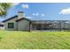 A view of the screened-in pool and exterior of this well-maintained home at 12910 Prestwick Dr, Riverview, FL 33579