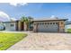 Attractive single-story house with brick accents, a two-car garage, and paved driveway at 12910 Prestwick Dr, Riverview, FL 33579
