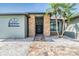 Inviting entryway with brick pillars, double doors, and meticulous landscaping at 12910 Prestwick Dr, Riverview, FL 33579