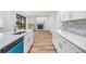 Open kitchen with white cabinets, quartz countertops, stainless steel appliances, and a fireplace at 12910 Prestwick Dr, Riverview, FL 33579