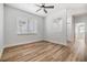 Spacious living room featuring updated wood floors, ceiling fan, and abundant natural light at 12910 Prestwick Dr, Riverview, FL 33579