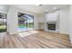 Living room with fireplace and sliding glass doors showcasing the inviting screened-in pool area and backyard at 12910 Prestwick Dr, Riverview, FL 33579