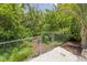 Backyard gate with crushed rock creating a secluded retreat within nature at 1600 Lonesome Pine Ln, Tarpon Springs, FL 34689