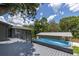 Backyard deck with above ground pool and covered patio at 1600 Lonesome Pine Ln, Tarpon Springs, FL 34689