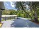 Backyard deck with above ground pool and fenced yard at 1600 Lonesome Pine Ln, Tarpon Springs, FL 34689