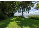 Peaceful backyard with a view of the lake and dock at 1600 Lonesome Pine Ln, Tarpon Springs, FL 34689