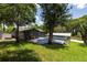Spacious backyard with deck, above ground pool, and mature landscaping at 1600 Lonesome Pine Ln, Tarpon Springs, FL 34689