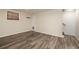 Finished basement area with wood-look flooring and natural light at 1600 Lonesome Pine Ln, Tarpon Springs, FL 34689