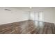 Finished basement area with wood-look flooring and glass patio doors at 1600 Lonesome Pine Ln, Tarpon Springs, FL 34689