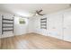This spacious bedroom offers wood-look floors, two large closets, and wall mounted shelving at 1600 Lonesome Pine Ln, Tarpon Springs, FL 34689