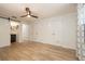 Spacious bedroom features wood-look flooring, access to the ensuite, and multiple closets for storage at 1600 Lonesome Pine Ln, Tarpon Springs, FL 34689