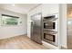 Bright kitchen showcasing stainless steel appliances, white cabinets, and wood floors at 1600 Lonesome Pine Ln, Tarpon Springs, FL 34689