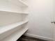 Pantry with white shelves and vinyl flooring at 1600 Lonesome Pine Ln, Tarpon Springs, FL 34689