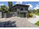 Two-story home featuring a screened in porch on the second level and landscaped garden beds at 1600 Lonesome Pine Ln, Tarpon Springs, FL 34689