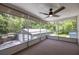 View from sunroom of a detached garage, backyard, trees, and neighboring homes at 1600 Lonesome Pine Ln, Tarpon Springs, FL 34689