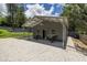 Exterior view of metal workshop with covered parking, gravel, and easy access at 1600 Lonesome Pine Ln, Tarpon Springs, FL 34689