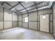 Bright workshop featuring concrete floor, window, and pedestrian door for utility or hobbies at 1600 Lonesome Pine Ln, Tarpon Springs, FL 34689
