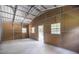 Large workshop interior with natural light, concrete floor, and neutral wall colors at 1600 Lonesome Pine Ln, Tarpon Springs, FL 34689
