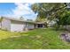 Spacious backyard with a mix of grass and patio, perfect for outdoor enjoyment at 16113 Tampa St, Lutz, FL 33548