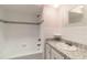Bathroom features tiled shower and tub combination, granite countertop, and chrome hardware at 16113 Tampa St, Lutz, FL 33548