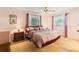 Spacious bedroom with ceiling fan, windows, and carpeted floors at 16113 Tampa St, Lutz, FL 33548