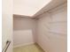 Walk-in closet featuring carpet, metal hanging rod, and built in white shelves at 16113 Tampa St, Lutz, FL 33548