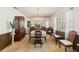 Formal dining room with chandelier, floral wallpaper, wood trim, and patterned rug at 16113 Tampa St, Lutz, FL 33548