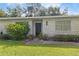 Charming home exterior featuring a brick facade, manicured lawn, and welcoming front entrance at 16113 Tampa St, Lutz, FL 33548