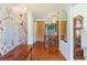 Hallway with wood floors and decorative wall art, connecting different parts of the home at 16113 Tampa St, Lutz, FL 33548