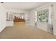Bright living room with carpet, large window, and view into dining area at 16113 Tampa St, Lutz, FL 33548