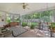 Relaxing screened porch with ample seating, ceiling fan, and views of the lush backyard at 16113 Tampa St, Lutz, FL 33548