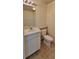 Bathroom featuring a toilet, sink with mirror, and linoleum flooring at 16501 Harper Pond Ln # 308, Odessa, FL 33556