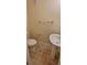 Compact bathroom featuring a toilet, pedestal sink, and tile flooring at 16501 Harper Pond Ln # 308, Odessa, FL 33556