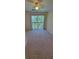A large bedroom with sliding glass doors and neutral carpet at 16501 Harper Pond Ln # 308, Odessa, FL 33556