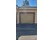 Exterior view of a one car garage with a neutral tone door and brick border at 16501 Harper Pond Ln # 308, Odessa, FL 33556