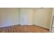 Bright living room featuring wood-look floors, neutral walls, and a large front door at 16501 Harper Pond Ln # 308, Odessa, FL 33556