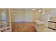 Open-concept living room with laminate flooring, spiral staircase, and kitchen with breakfast bar at 16501 Harper Pond Ln # 308, Odessa, FL 33556