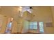 Open living space with soaring ceilings, spiral staircase, and bright balcony access at 16501 Harper Pond Ln # 308, Odessa, FL 33556