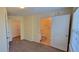 View of the main bedroom with neutral carpet leading to bathroom and closet space at 16501 Harper Pond Ln # 308, Odessa, FL 33556