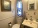 Functional bathroom with a toilet, sink, and floral decor at 1710 7Th Sw St # 39, Ruskin, FL 33570