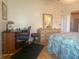 Bright bedroom featuring a desk, dresser, and comfortable bed at 1710 7Th Sw St # 39, Ruskin, FL 33570