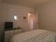 Cozy bedroom featuring a comfortable bed, dresser, and round mirror, creating a relaxing atmosphere at 1710 7Th Sw St # 39, Ruskin, FL 33570
