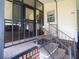 Inviting entrance with a screened-in porch and concrete steps with metal railing leading to the front door at 1710 7Th Sw St # 39, Ruskin, FL 33570