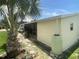 Tan home with a screened in porch area, lush green grass, and large palm tree at 1710 7Th Sw St # 39, Ruskin, FL 33570