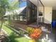 Well-maintained home featuring an enclosed porch, brick accents, and colorful flowering bushes at 1710 7Th Sw St # 39, Ruskin, FL 33570