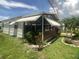Charming exterior view of the home with a screened lanai, awning, and well-maintained landscaping, enhancing curb appeal at 1710 7Th Sw St # 39, Ruskin, FL 33570