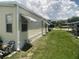 Exterior view of the home with awnings and a well-maintained lawn, offering a pleasant curb appeal at 1710 7Th Sw St # 39, Ruskin, FL 33570